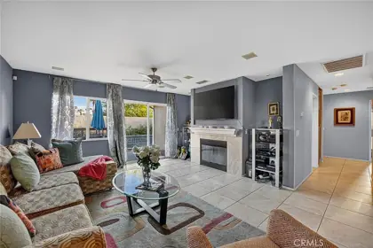 Open living room with tile floors and natural light